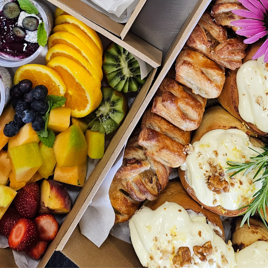 Assorted pastries and fruits in a box