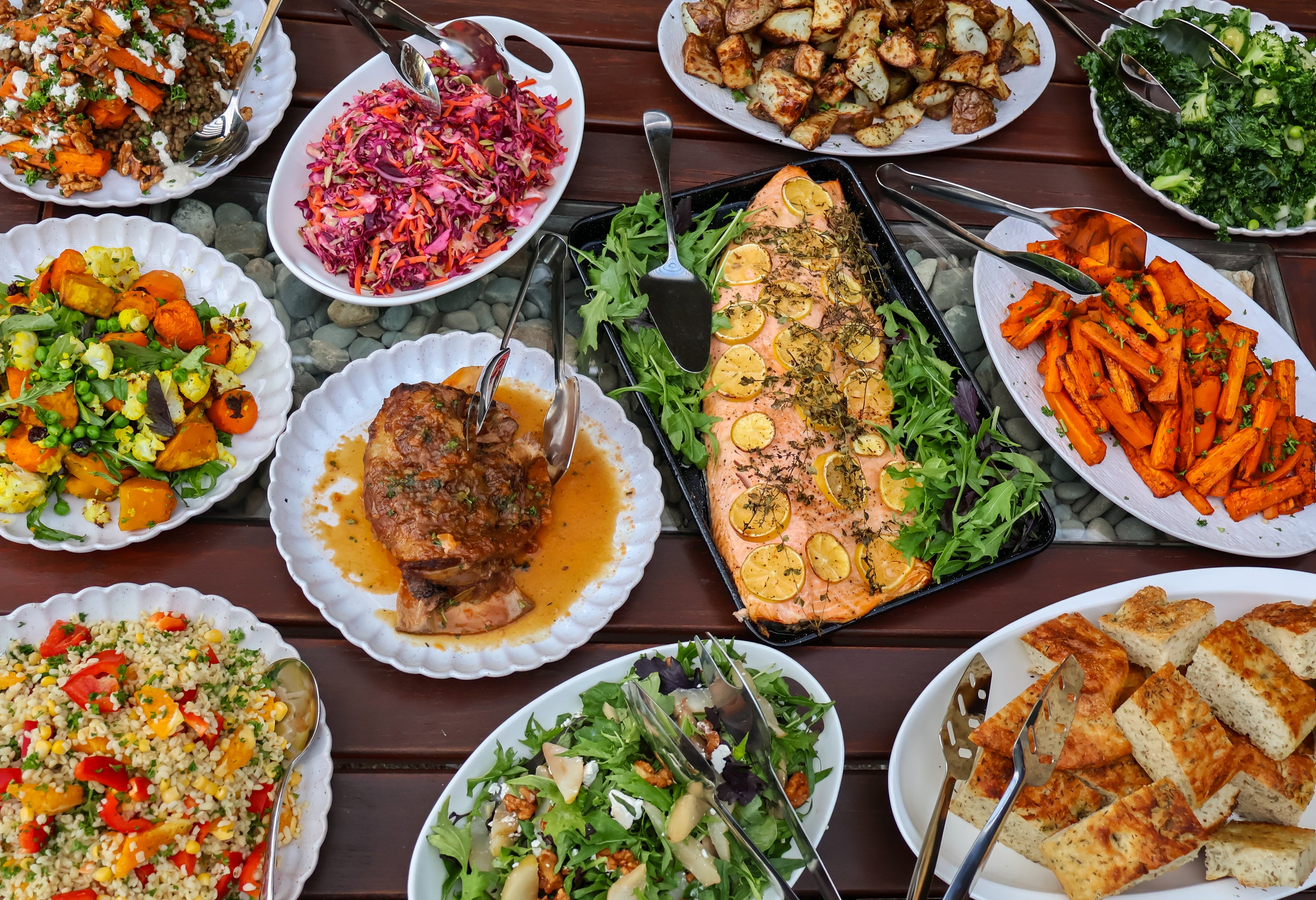 Long table catering display with colorful shared platters