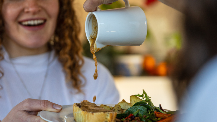Smiling woman enjoying delicious catering food by Well Catered in Wanaka